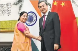  ?? REUTERS ?? External affairs minister Sushma Swaraj (L) shakes hands with Chinese Foreign Minister Wang Yi in Beijing on Sunday.