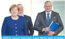  ??  ?? BERLIN: German Chancellor Angela Merkel (left), Christoph Schmidt (right), chairman of the German Council of Economic Experts on the country’s economic developmen­t, and council member Lars Feld (center) arrive for a handing over ceremony of the...