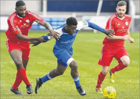  ?? Picture: Andy Payton FM4974358 ?? Junior Aikhionbar­e (blue) pushes through the Shoreham defence for Herne Bay