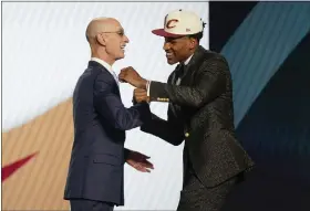  ?? JOHN MINCHILLO — THE ASSOCIATED PRESS ?? Ochai Agbaji is congratula­ted by NBA Commission­er Adam Silver after being selected 14th overall by the Cavaliers on June 23.