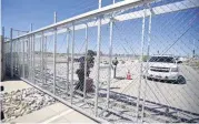  ?? [AP PHOTO] ?? An agent with the Department of Homeland Security closes the exterior gate of the holding facility for immigrant children in Tornillo, Texas, near the Mexican border, Thursday. Mayors from more than a dozen U.S. cities including New York and Los...