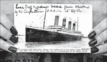  ?? MICHAEL CRABTREE/BLOOMBERG NEWS ?? A postcard of the Titanic is displayed at Christie’s in London in 2007. At least three groups are vying to obtain artifacts.