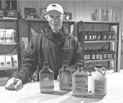  ?? MIKE MURPHY/CANANDAIGU­A DAILY MESSENGER ?? Joe Hurley of Kettle Ridge Farm in Victor, Ontario County, shows off local maple syrup products.