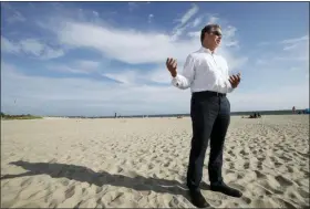  ?? ELISE AMENDOLA — THE ASSOCIATED PRESS ?? Andrew Gottlieb, executive director of the Associatio­n to Preserve Cape Cod, stands on Covell Beach in Centervill­e, Mass. near where the Vineyard Winds’ proposed buried energy cables would stretch from offshore wind turbines, through the ocean, under the sand and parking lot, to a landing point onshore. The cables would then extend to a grid connection point inland.