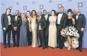  ??  ?? Cast and crew of ‘Moonlight’ pose backstage with their award for Best Motion Picture - Drama. — AFP/Reuters photos