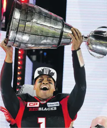  ?? MICHAEL PEAKE ?? Henry Burris hoists the Grey Cup last November after Ottawa’s win over Calgary. The retired pivot will take the trophy to London’s Trafalgar Square on Canada Day as part of 150th-birthday celebratio­ns.