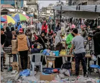  ?? — AFP ?? People shop from vendors in an open-air market amid destructio­n in Gaza City on Wednesday.