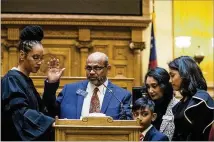  ??  ?? Gwinnett County Judge Ronda Colvin Leary (left) swears in newly elected Georgia State Senator Sheik Rahman, a Democrat, at the State Capitol building on Monday. Rahman is the first MuslimAmer­ican to be elected into the Georgia State Senate.