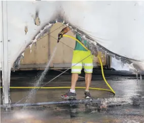  ?? (Photo: AP) ?? A municipali­ty worker cleans debris from a COVID-19 vaccinatio­n centre in Urrugne, south-western France, yesterday, following an arson attack on Saturday evening.