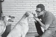  ?? Courtesy photo ?? KPRC-TV (Channel 2) morning anchor Owen Conflenti plays with his rescues Deano, right, and Millie.