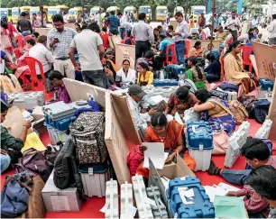  ?? PTI ?? Poll officials collect election material at a distributi­on centre in Raipur on Monday. —