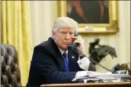  ?? ALEX BRANDON — THE ASSOCIATED PRESS ?? U.S. President Donald Trump speaks on the phone with Prime Minister of Australia Malcolm Turnbull in the Oval Office of the White House in Washington.