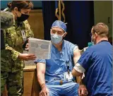  ?? TY GREENLEES /
U.S. AIR FORCE ?? U.S. Air Force Maj. Richard Brocksmith, 88th Medical Group nurse anesthetis­t, receives the COVID-19 vaccine at WrightPatt­erson Air Force Base on Jan. 4.