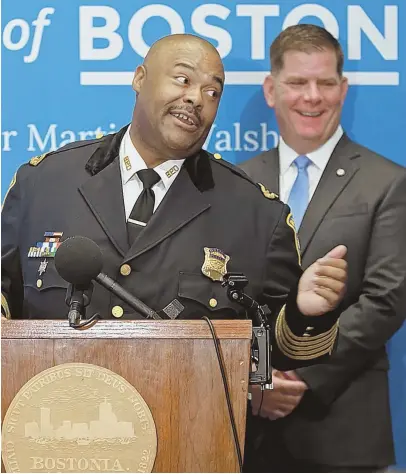  ?? STAFF PHOTO BY MATT STONE ?? STEPPING IN: Mayor Marty Walsh laughs as newly appointed Boston police commission­er William G. Gross speaks at City Hall yesterday.