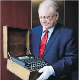  ??  ?? H. Keith Melton, holds an Enigma machine that was used in the Second World War to encode messages. It’s part of his collection of thousands of items that he’s donating to the Internatio­nal Spy Museum.