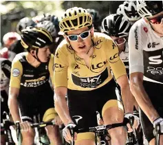  ??  ?? Geraint Thomas (centre), wearing the overall leader’s yellow jersey, and Great Britain’s Christophe­r Froome (right) ride in the pack during the 15th stage of the 105th edition of the Tour de France cycling race, between Millau and Carcassonn­e. — AFP photo