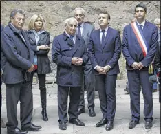  ?? AP ?? French candidate Emmanuel Macron (second right) and Robert Hebras (center left), last living survivor of the 1944 Oradour-sur-Glane massacre, visit ruins in Oradoursur-Glane on Friday. France’s troubled wartime past is taking center stage as Marine Le Pen’s far-right party suffered a new blow over alleged Holocaust denial.