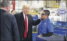  ?? EVAN VUCCI / AP 2016 ?? In December, President-elect Donald Trump talks with workers at the Carrier factory in Indianapol­is. Trump wants to encourage apprentice­ship programs.