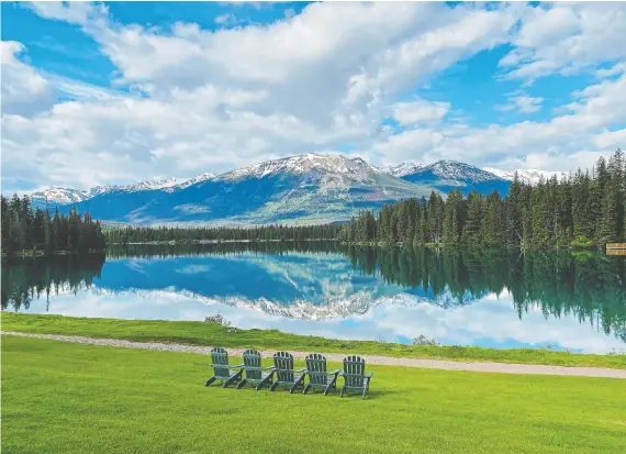  ?? GREG OLSEN ?? Jasper National Park is renowned for its scenic beauty, with breathtaki­ng vistas such as this reflection in Lac Beauvert.