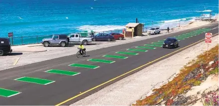  ?? PHIL DIEHL U-T ?? Carlsbad added green paint last week on Carlsbad Boulevard to urge caution in areas where drivers and cyclists must share the road.