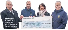  ??  ?? SUPPORT Martina is presented with cheque by GAA chairmen