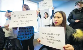  ?? ARLEN REDEKOP/PNG ?? Āorkers and supporters hold up signs during a press conference at the B.C. Federation of Labour office in Vancouver on Monday.