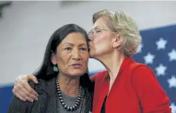  ?? Angela Rowlings, Boston Herald ?? Sen. Elizabeth Warren kisses Congresswo­man Deb Haaland during a presidenti­al campaign rally for Warren at the Rundlett Middle School on Feb. 9, 2020 in Concord, Mass.
