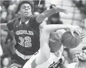  ?? STEPHEN M. DOWELL/ORLANDO SENTINEL ?? Seminole’s Jovaughn Douglas (32) reaches to block a shot by Oviedo guard Jimmy Chapman (bottom).