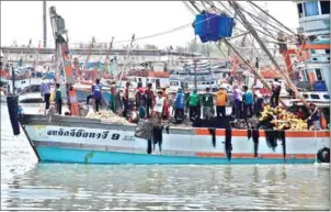  ??  ?? A crowded Thai fishing vessel comes in to port. A report from Human Rights Watch found that migrant fishermen – many of them Cambodian – are still victims of abuse and slavery in the lucrative Thai fishing industry.