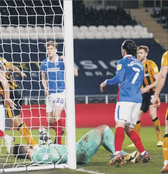  ?? Pictures: Daniel Chesterton/phcimages.com ?? Magennis turns the ball into his own net under pressure from Pompey striker John Marquis for Blues’ second goal.