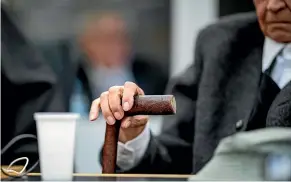  ?? AP ?? A former 94-year-old SS guard holds his walking stick at the beginning of a trial in Muenster. He is charged with being an accessory to murder for serving at the Nazis’ Stutthof concentrat­ion camp.