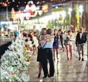  ?? AFP FILE ?? People pay tribute to the victims of the truck attack at the Promenade des Anglais in Nice.