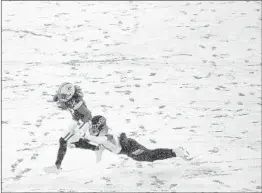  ?? Morry Gash A s s o c i a te d P re s s ?? GREEN BAY’S Davante Adams, who caught three of Aaron Rodgers’ four touchdown passes, tries to get past Tennessee Titans’ David Long during the f irst half.