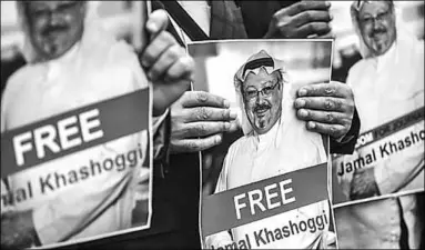  ??  ?? Protesters in Istanbul hold pictures of missing journalist Jamal Khashoggi on Monday. (Photo: AFP/Getty Images)