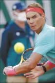  ?? AP photo ?? Rafael Nadal eyes the ball during his 6-3, 6-3, 7-6 (0) victory over Diego Schwartzma­n in the French Open semifinals Friday.