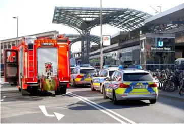  ??  ?? German police vehicles are parked near the main train station in Cologne, after the train station was closed due to a hostage-taking incident. — Reuters photo