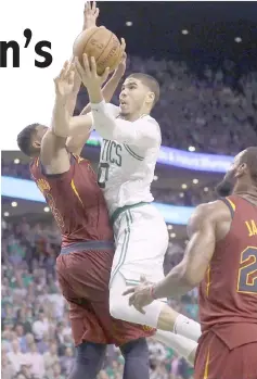  ?? — AFP photo ?? Jayson Tatum (centre) of the Boston Celtics drives to the basket in the second half against Tristan Thompson (left) of the Cleveland Cavaliers during Game Two of the 2018 NBA Eastern Conference Finals at TD Garden in Boston, Massachuse­tts.