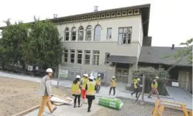  ?? Photo by Ted S. Warren, AP ?? Visitors wearing safety vests and hard hats begin a tour of the Destiny Charter Middle School in July 2015 in Tacoma, Wash. The school opened later in 2015. All told, the Bill and Melinda Gates Foundation has given about $25 million to the Washington...