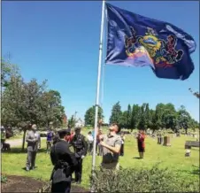  ?? EVAN BRANDT — DIGITAL FIRST MEDIA ?? Andrew Seanor raises the Pennsylvan­ia flag during a Flag Day ceremony Thursday at Edgewood Cemetery in Pottstown.