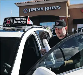  ?? JOHN LOCHER / THE ASSOCIATED PRESS ?? Food delivery services like Uber Eats and GrubHub are taking off like a rocket, but some restaurant­s aren’t on board. This week, Jimmy John’s sandwich chain launched a national ad campaign promising never to use third-party delivery.