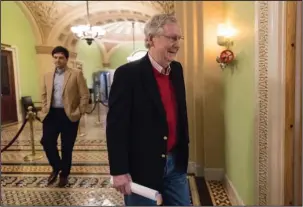 ?? The Associated Press ?? CHRISTMAS RECESS: Ready to leave for the Christmas recess, Senate Majority Leader Mitch McConnell, R-Ky., walks to a news conference to discuss the GOP agenda for next year and and his accomplish­ments in the first year of the Trump Administra­tion,...