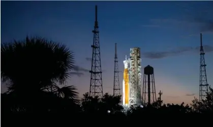  ?? Photograph: Joel Kowsky/Nasa/AFP/Getty Images ?? Nasa's Space Launch System rocket with the Orion spacecraft aboard is illuminate­d after sunset at the Kennedy space center in Florida.