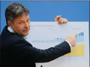  ?? (AP/Markus Schreiber) ?? German Economy and Climate Minister Robert Habeck points to a poster with a graphic detailing wind energy and photovolta­ic expansion Tuesday during a news conference about the German government climate policy in Berlin.