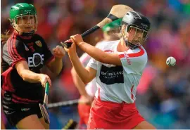  ?? PIARAS Ó MÍDHEACH/SPORTSFILE ?? Caitríona Collins rifles home Cork’s second-half goal despite the efforts of Down’s Allannah Savage in yesterday’s intermedia­te final