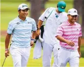  ?? CURTIS COMPTON AP ?? Hideki Matsuyama (left) and Xander Schauffele smile after they made eagle putts on the 15th green.