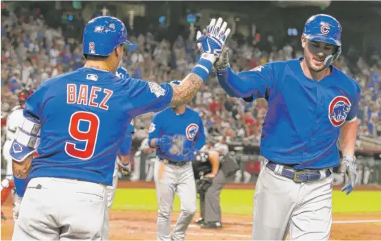  ?? ROSS D. FRANKLIN/AP ?? Kris Bryant celebrates his two-run homer with Javy Baez in the eighth inning Monday against the Diamondbac­ks. It was Bryant’s first homer since July 21.