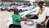  ??  ?? Choppies Human Resources Manager Mr Sipho Mpofu hands over Chevrolet car keys to Choppies grand winner Mr Cleto Imbayago at Nkulumane Complex