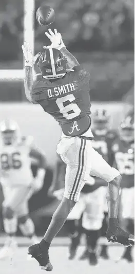  ?? KEVIN C.COX/GETTY(WILLIAMS)
MIKE EHRMANN/GETTY(JONES,SABAN) ?? Alabama quarterbac­k Mac Jones and coach Nick Saban, left, celebrate a blowout victory over Ohio State, a win that was helped in large part by DeVonta Smith, top.