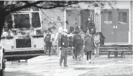  ?? ALEX BRANDON/AP ?? Police move students into a different area of Great Mills High School in St. Mary’s County Tuesday morning following a shooting on site.