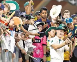  ??  ?? Marnus Labuschagn­e takes selfies with fans after Australia’s win against New Zealand in Perth.
GETTY